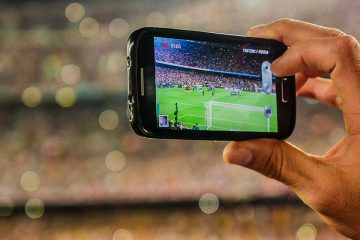 Holding mobile phone to take photo in stadium