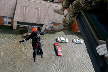 Rescue operation from helicopter in flood zone