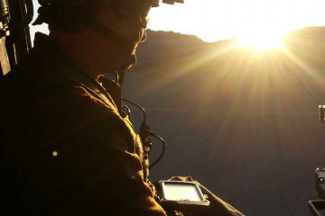 Soldier using smartphone before deployment