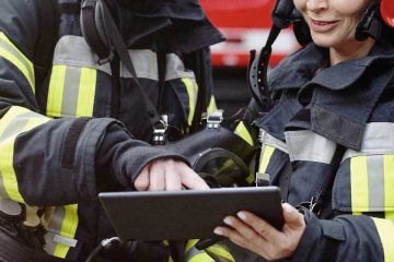 Firefighters looking at tablet